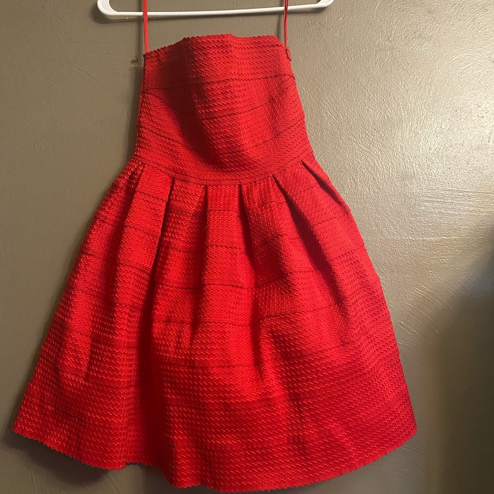 Woman’s red strapless dress